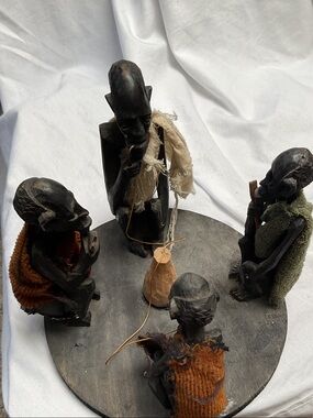 Handcrafted Black Wood Tribal Storytelling Sculpture with Neutral Fabric Accents